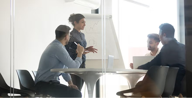 Business team meeting in glass-walled conference room