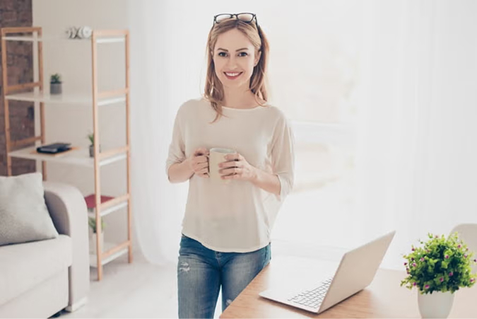 Woman taking study break with coffee in home office
