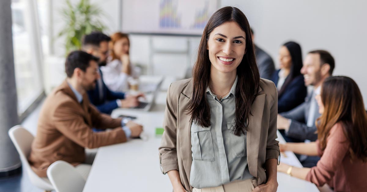 Woman standing in front of a group of people.