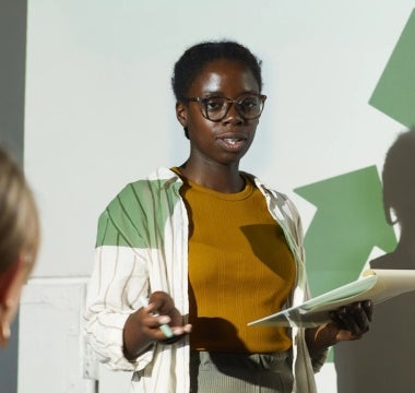 Young woman giving presentation on ESG impact