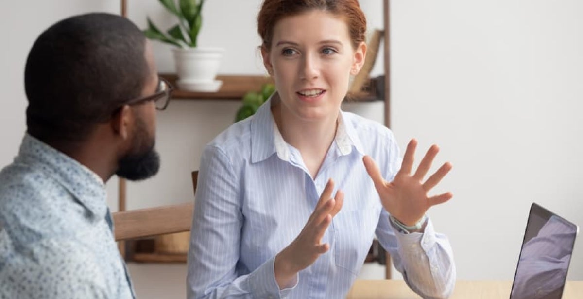 "A female HR manager speaking to a colleague"