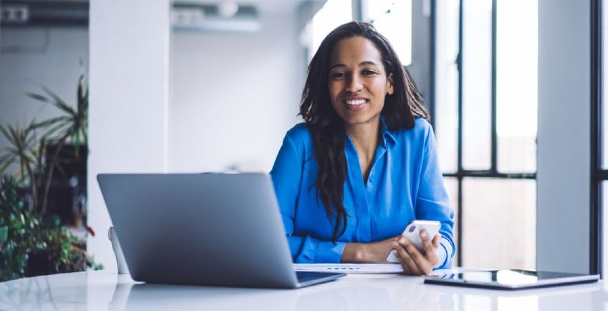 "Human resource manager sitting at desk with laptop"