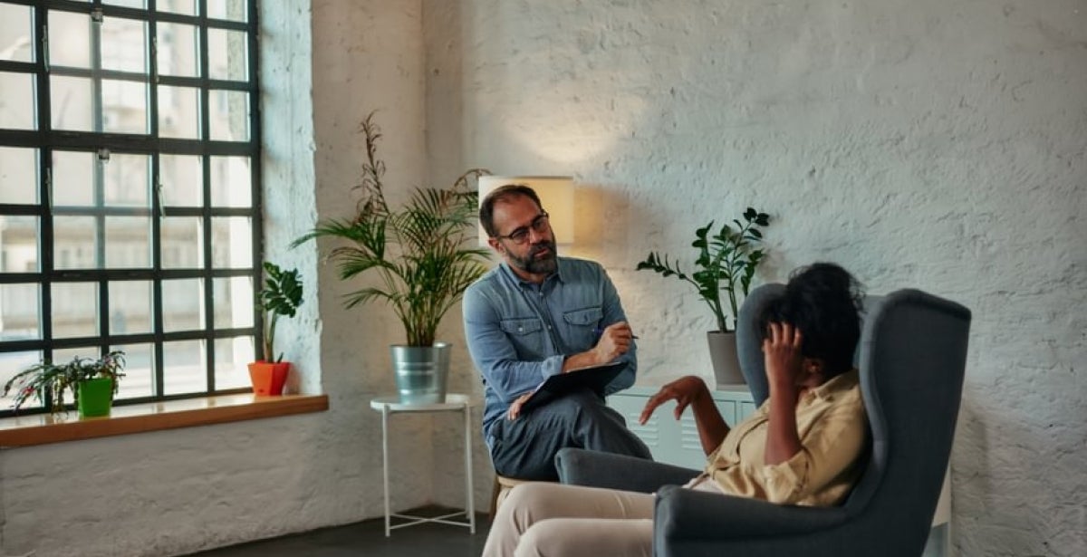 A psychologist listens to a client