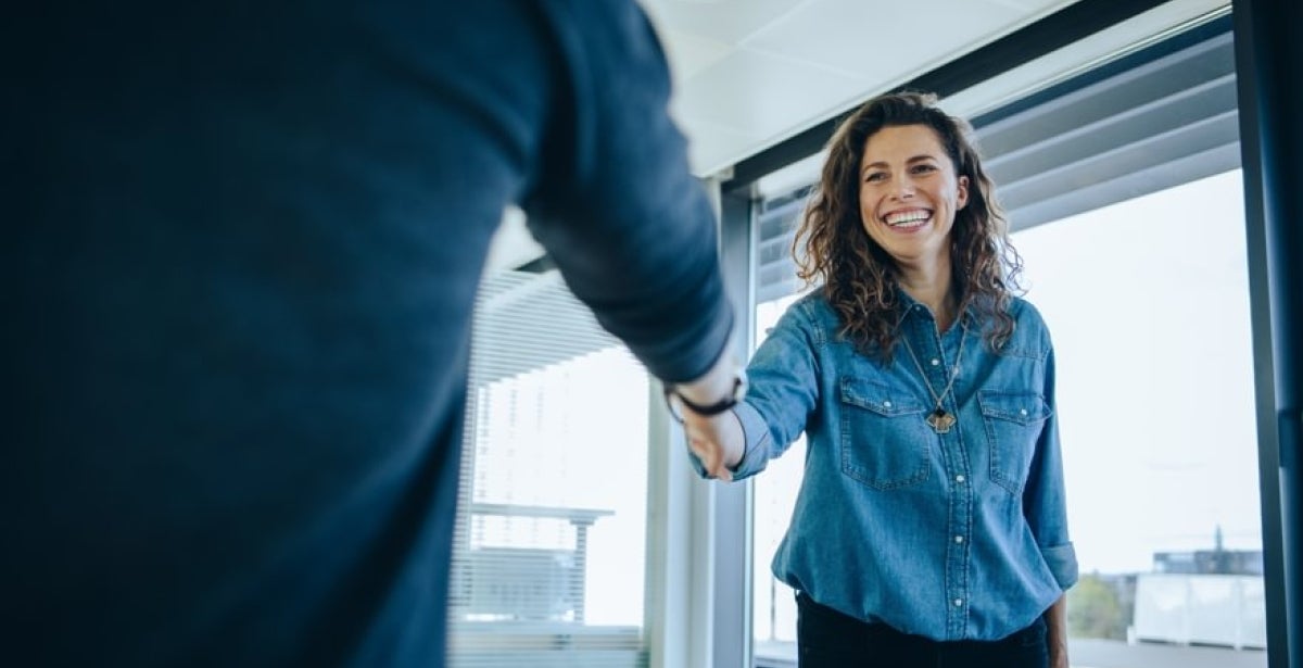 HR Manager shaking hands with coworker after meeting