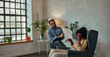A psychologist listens to a client