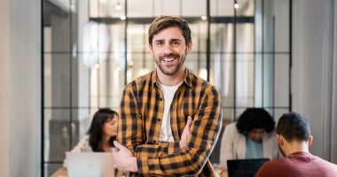 A PR practitioner smiling at workplace